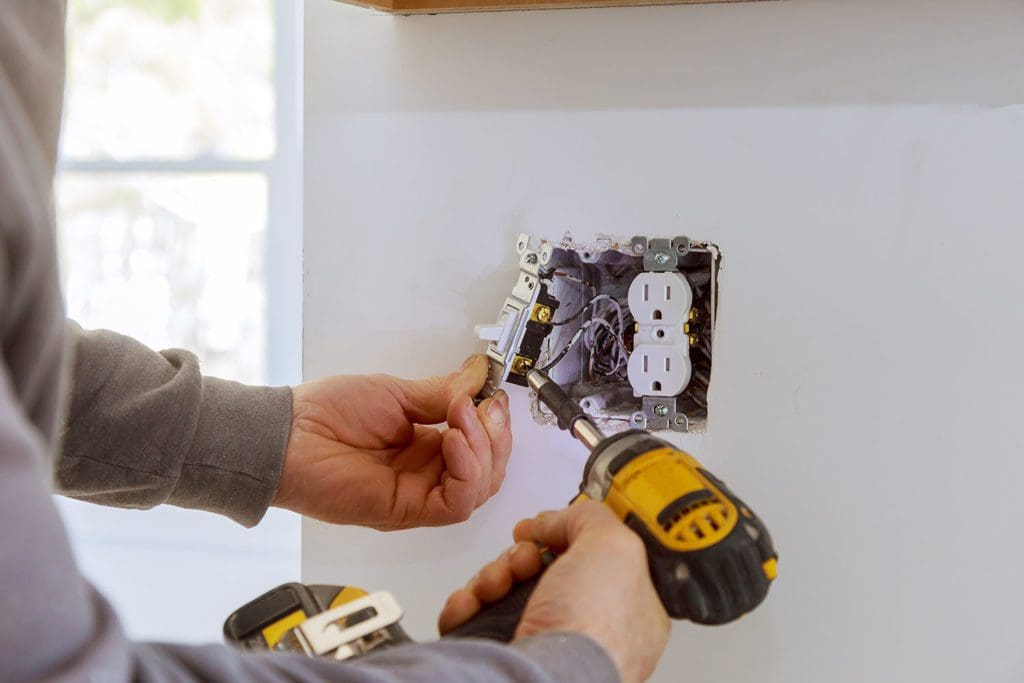 Electrician installing electrical outlets