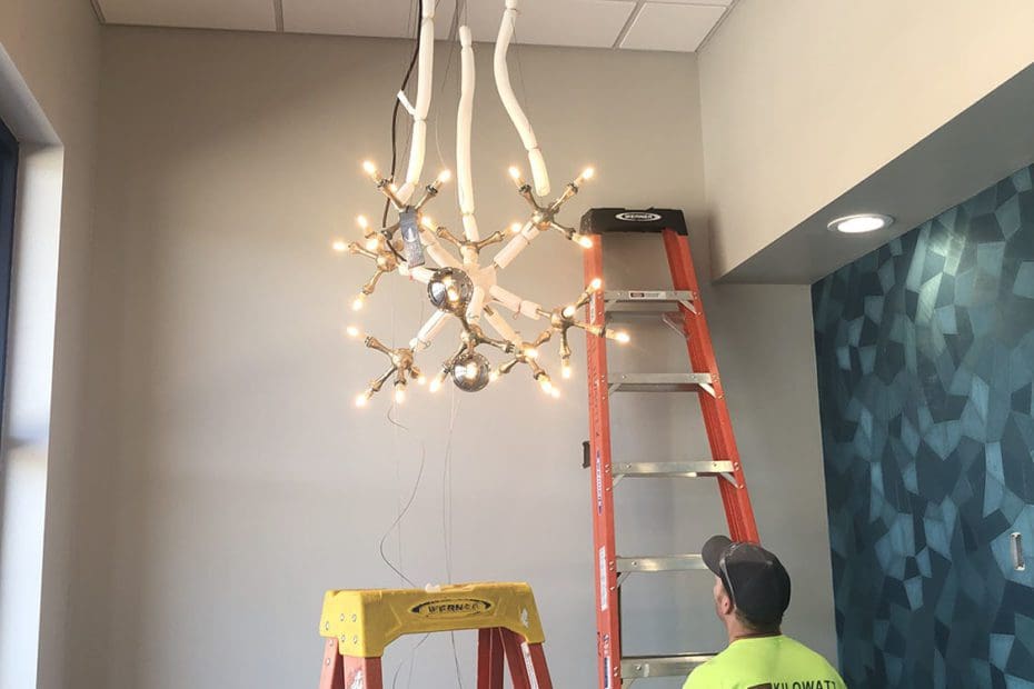 Interior installation of chandelier lighting in West river Surgical Clinic by Kilowatt Electric in Rapid City, SD.