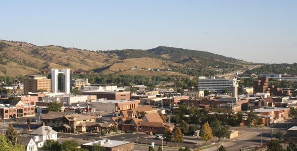 Rapid_City_Skyline_(2022) by WeaponizingArchitecture via wikimedia commons and CC BY-SA 4.0 Photo of Rapid City, South Dakota skyline