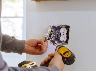 Electrician installing electrical outlets Electrician installing electrical outlets